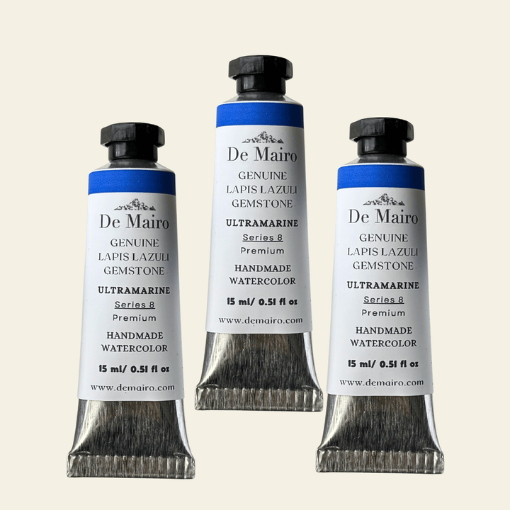 Three tubes of De Mairo watercolor paint on a white background