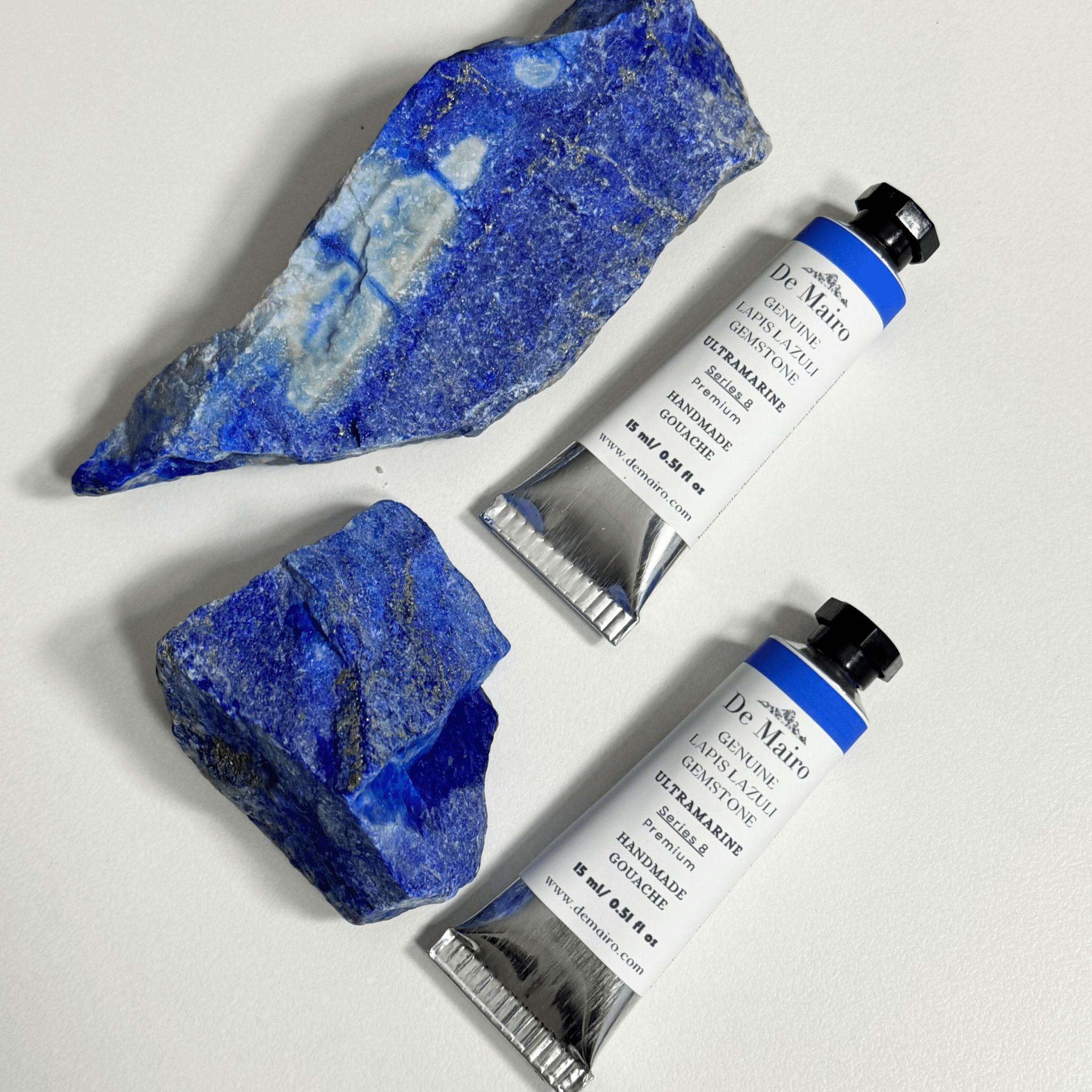 Two tubes of Dr. Mario eyelash gel with blue stones on a white background