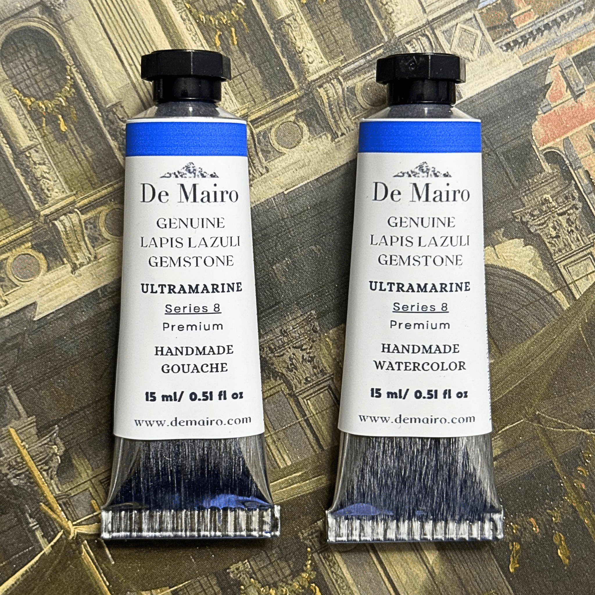 Two De Mairo ultramarine tubes of watercolor and gouache on a decorative background