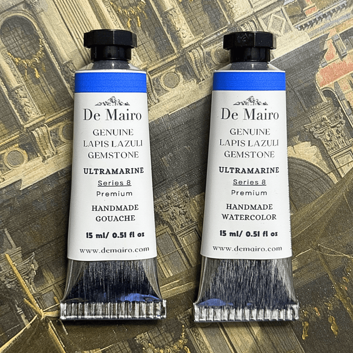 Two De Mairo ultramarine tubes of watercolor and gouache on a decorative background