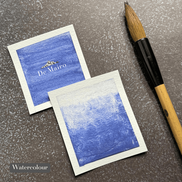 Genuine Lapis Lazuli Indigo Shade Pigment watercolour swatches besides a paintbrush