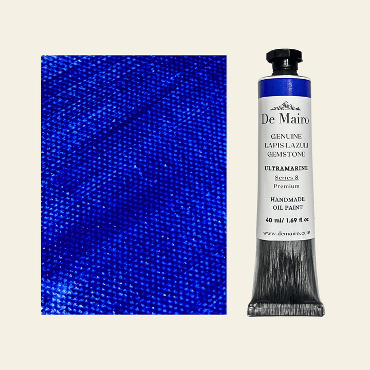 Tube of De Mairo oil paint with a swatch of blue color on a beige background