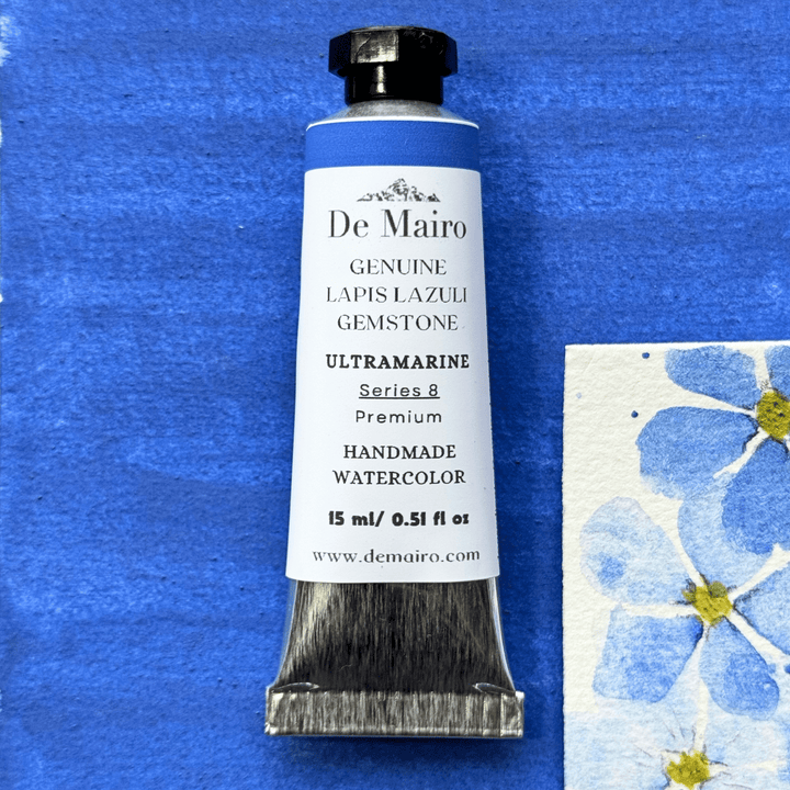 Lapis Lazuli Ultramarine Watercolor Tube over a swatch and some drawn flowers