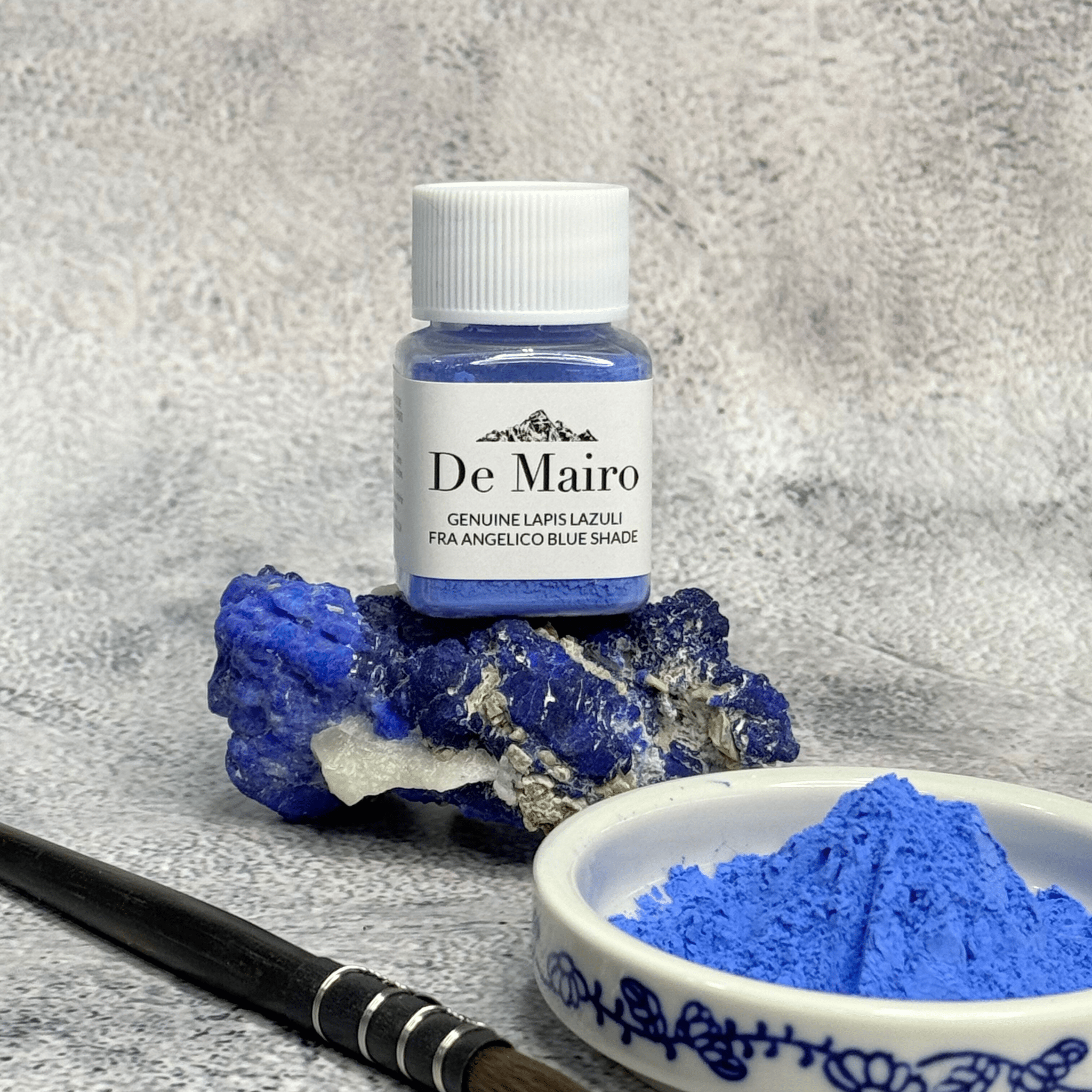 De Mairo Fra Angelico blue pigment jar with raw Afghan lapis lazuli, a brush, and a dish of natural Fra Angelico pigment