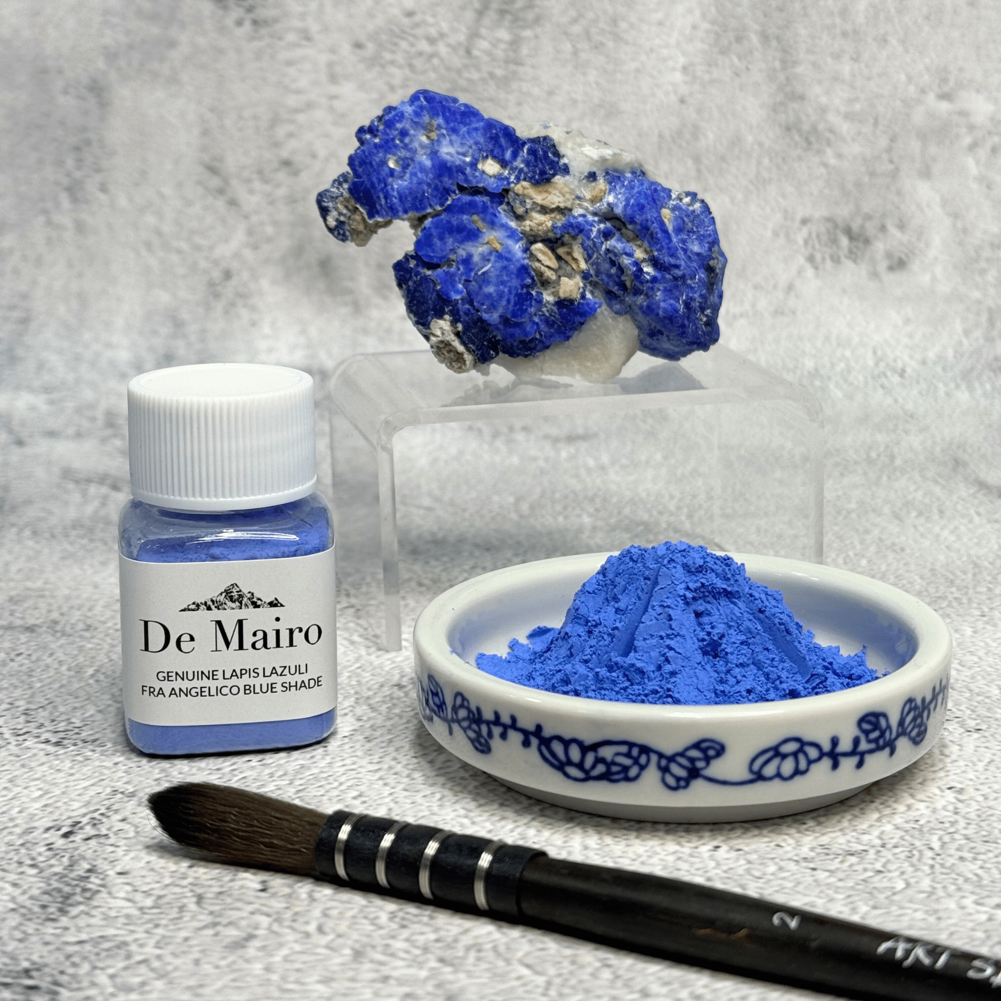 De Mairo Fra Angelico pigment jar topped with raw Afghan lapis lazuli, with a dish of blue pigment and a paintbrush