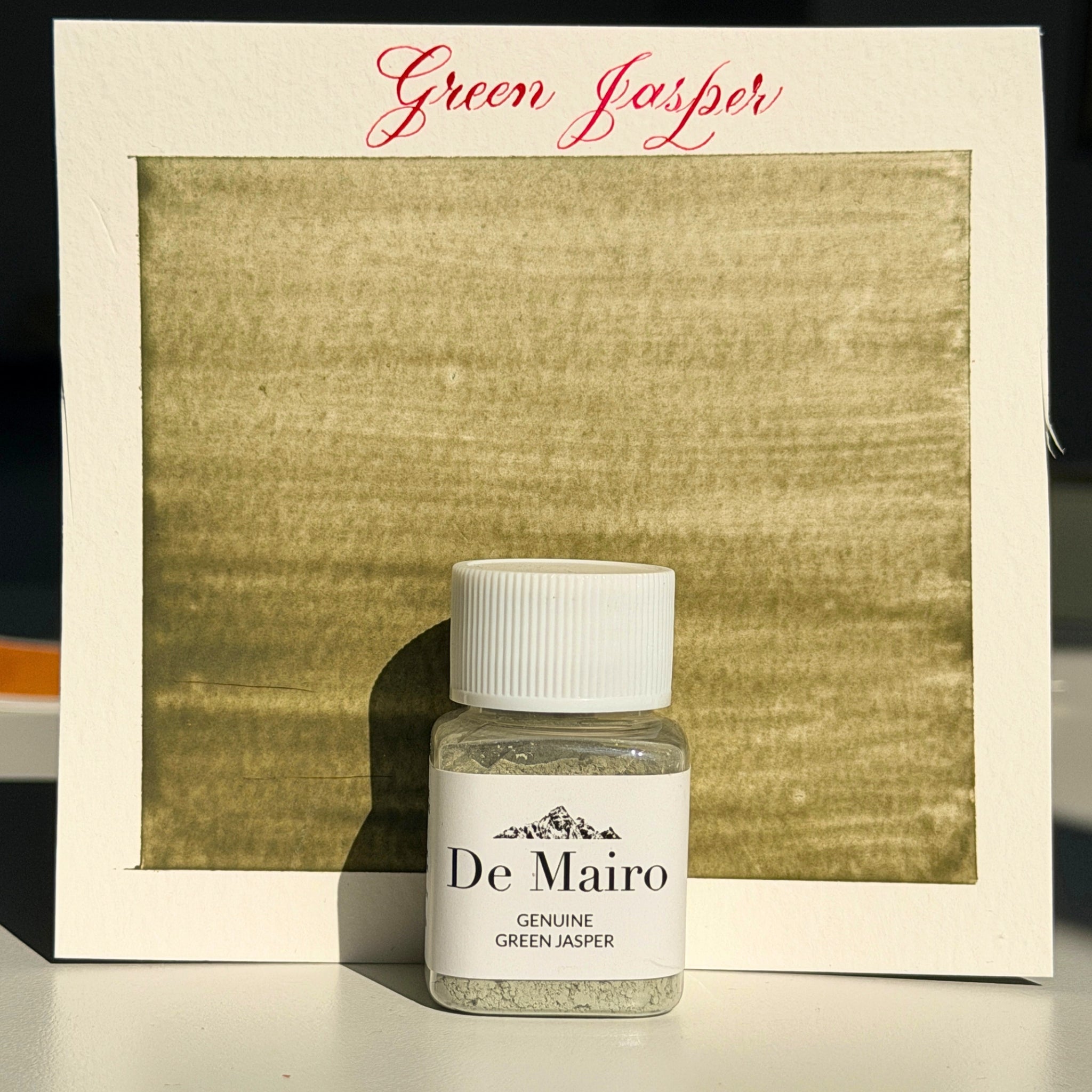 Green Jasper pigment swatch in muted olive green with the De Mairo bottle