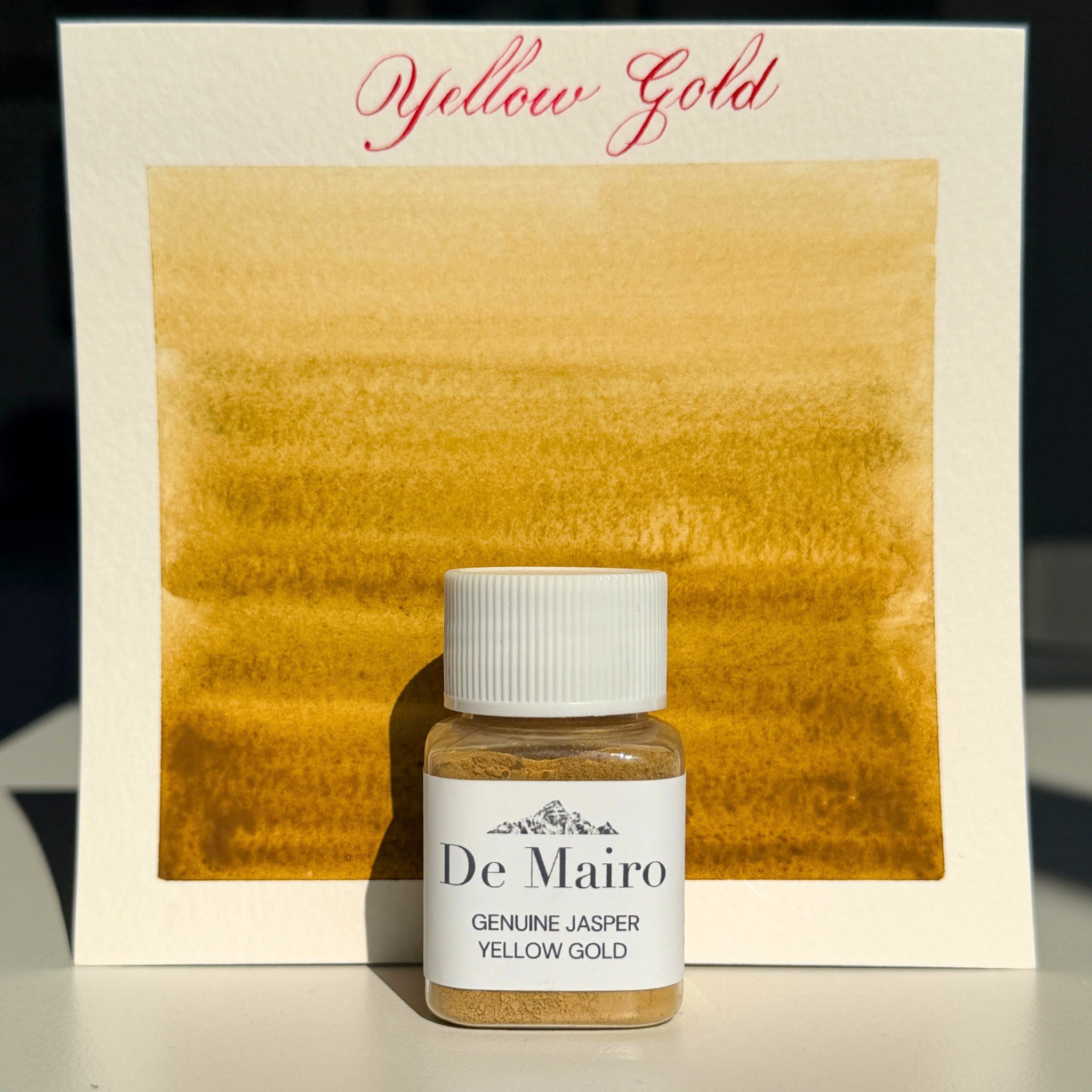 Yellow Gold jasper pigment swatch with the De Mairo bottle