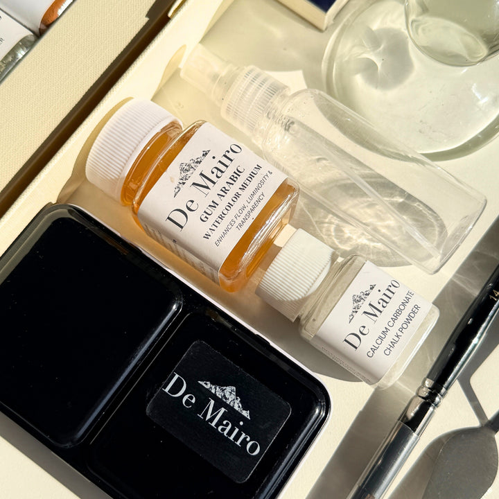 De Mairo gum arabic and calcium carbonate mediums beside the watercolour tin